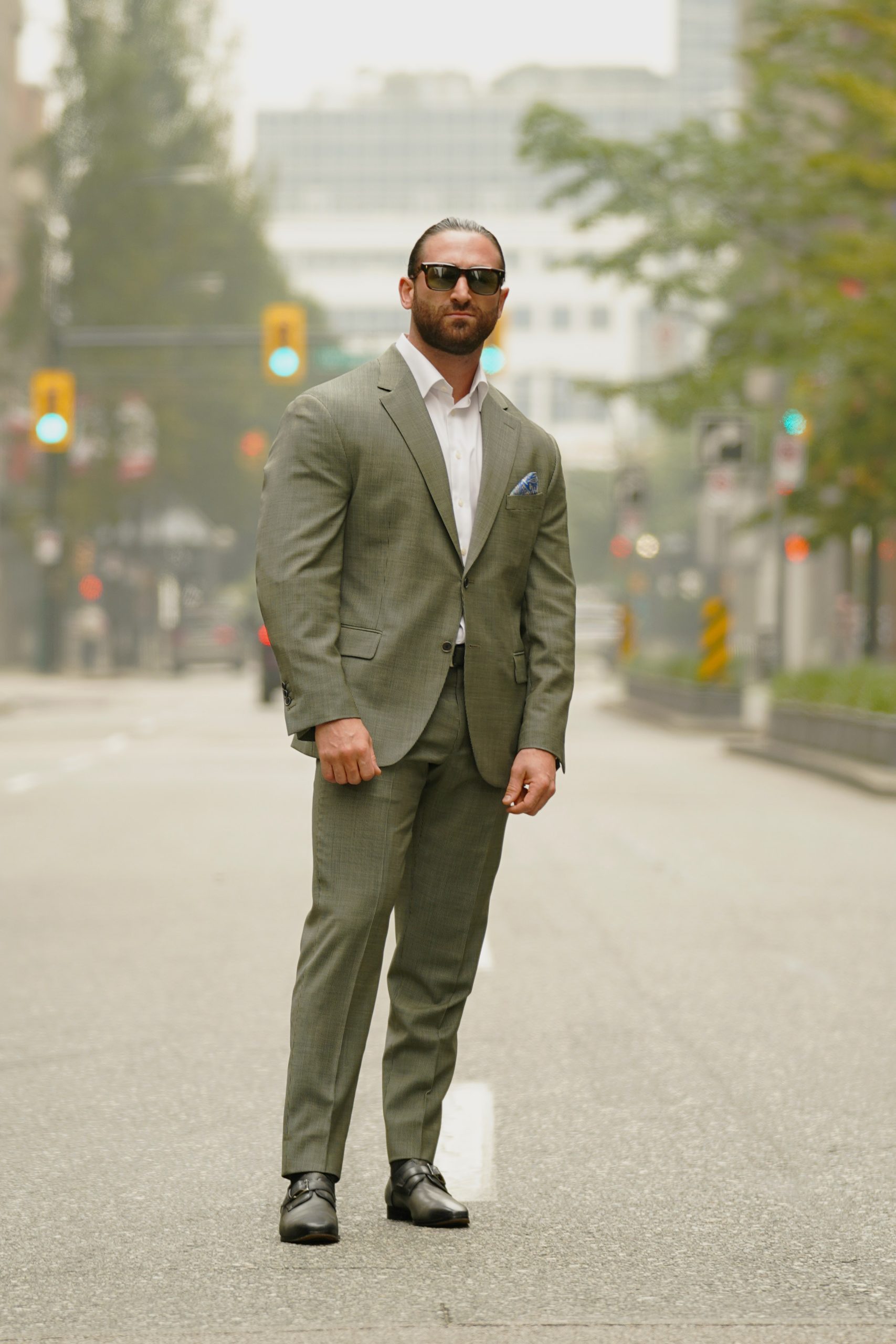 Athletic man in a properly fitted tailored suit, confident posture, Vancouver.