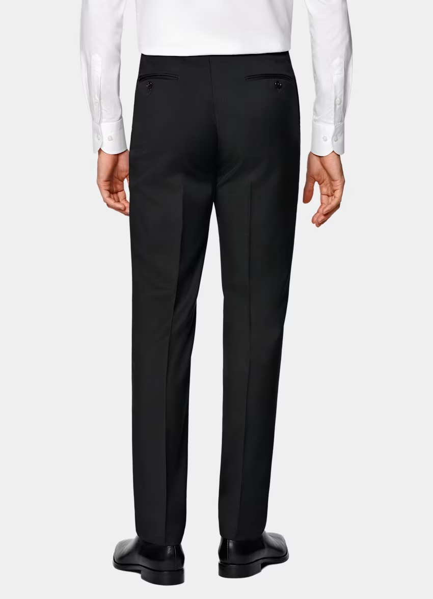 Properly fitted suit trousers on an athletic build with clean drape and no pulling.